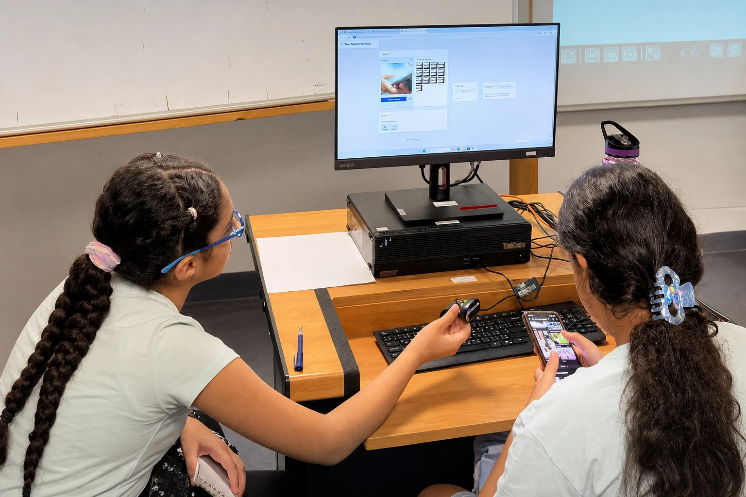 Students training and testing an AI webcam model