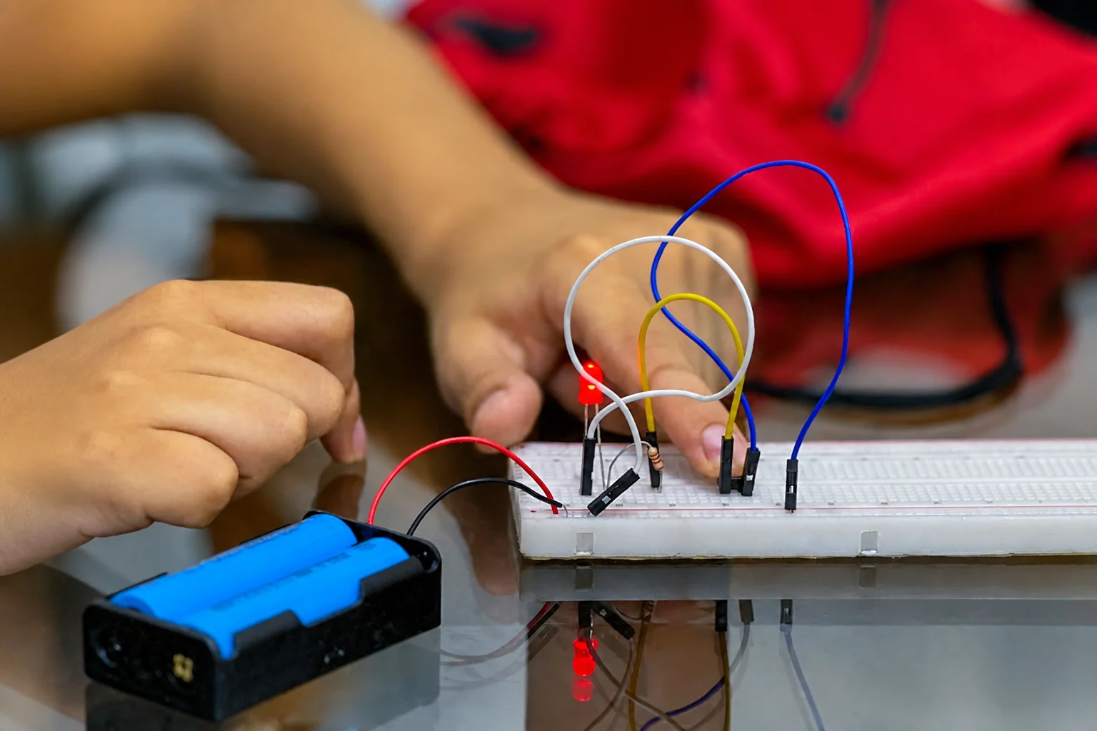 Student building and testing a breadboard circuit
