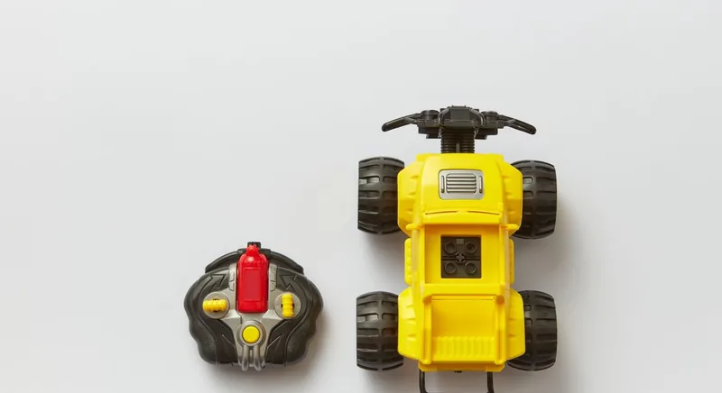 Remote-controlled vehicle beside its wireless controller